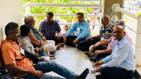 indian male delegates to the WSF sitting on the floor